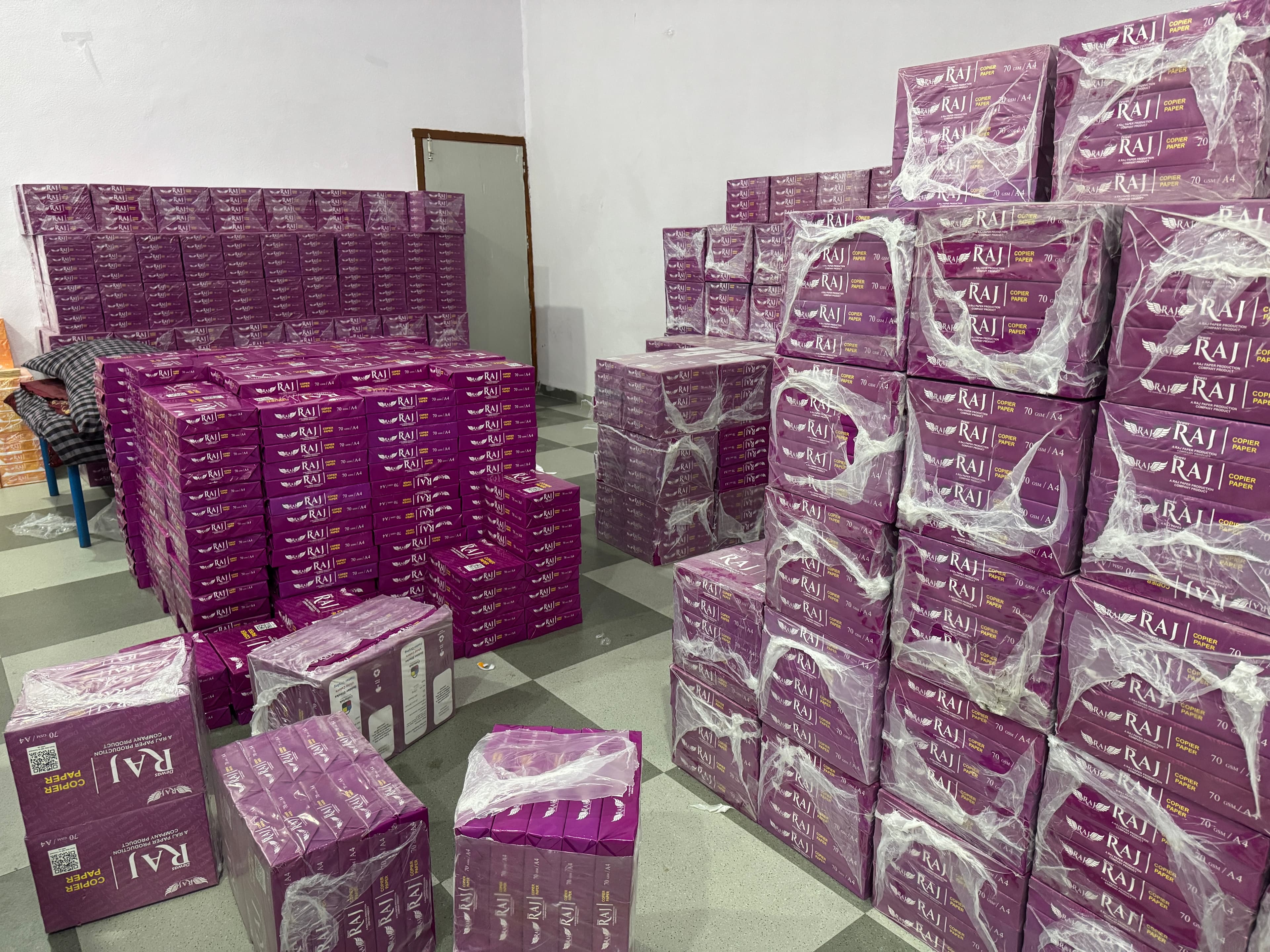 Pallets of Dewas Raj stationery cartons stacked in the warehouse