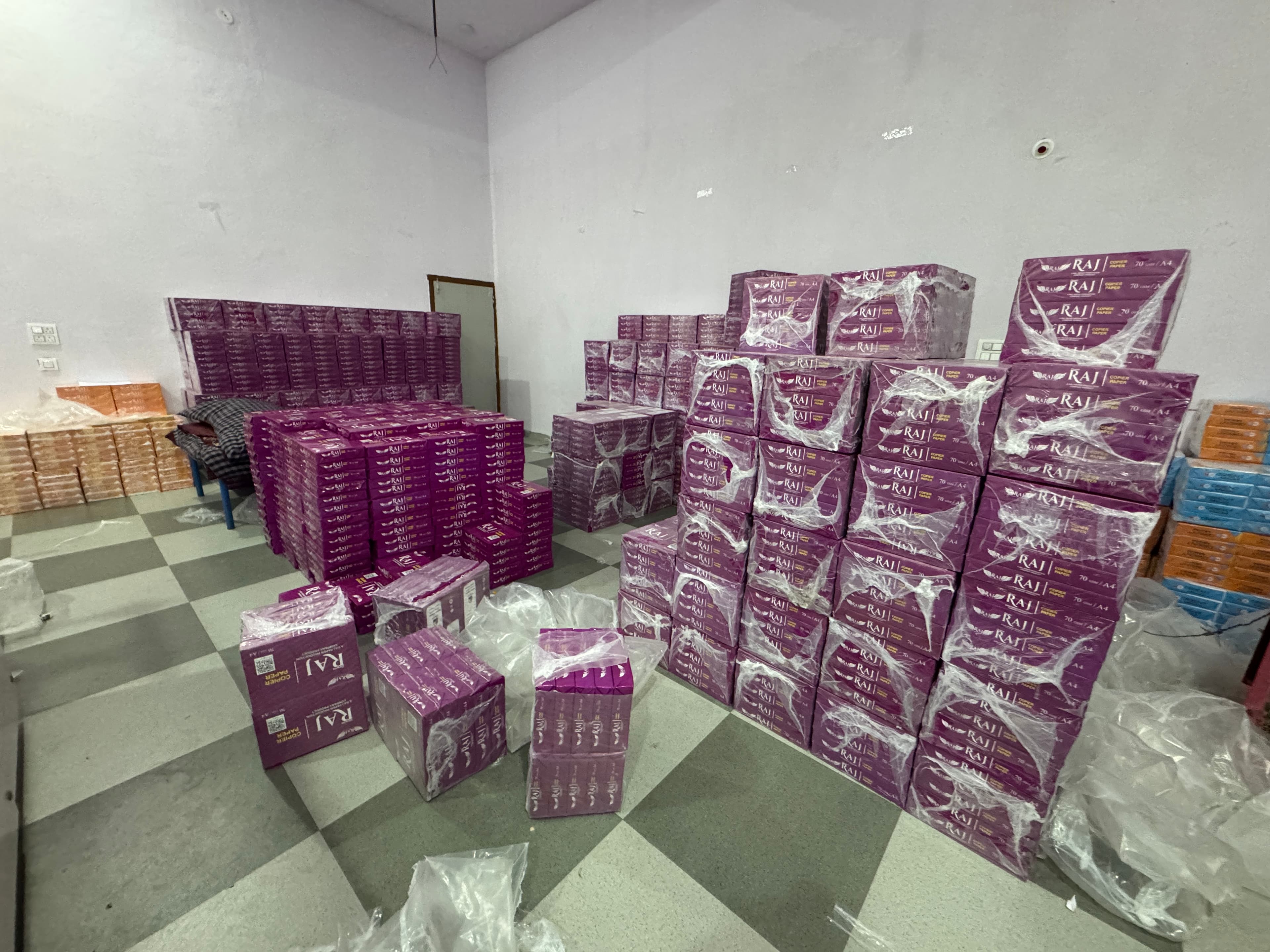 Warehouse stacked with cartons of Dewas Raj branded copier paper